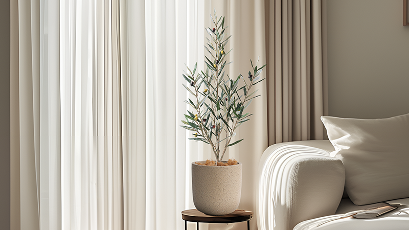 Small artificial olive tree in pot, elegant home decoration for modern interiors.