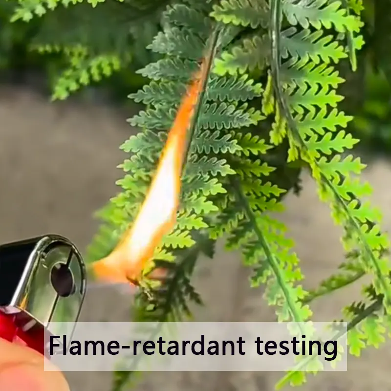 Flame-retardant material test Testing flame-retardant properties on artificial green leaves with a lighter.