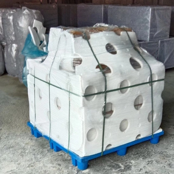 Wrapped pots molds on a blue pallet for shipment.