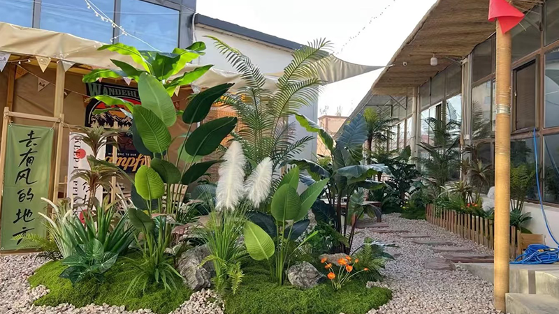 tropical plants outdoor decor with stone path and wooden fence