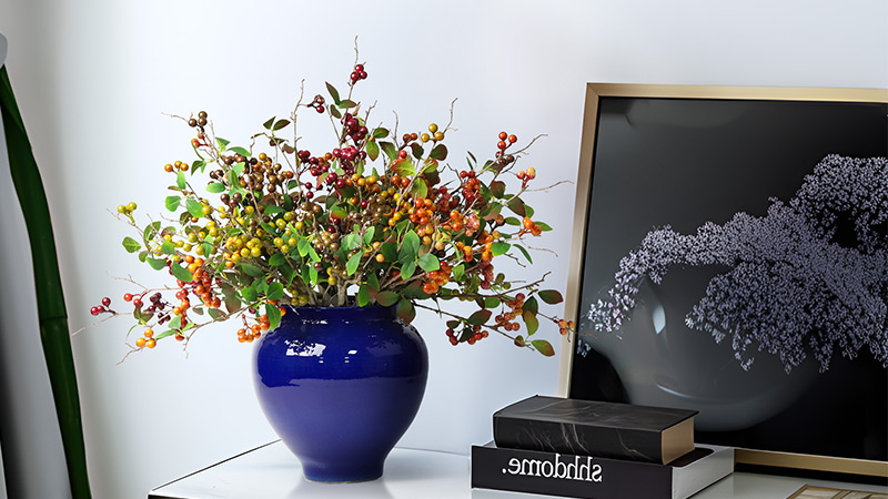 Artificial berry plant arrangement Artificial berry plant arrangement in blue ceramic pot, perfect for home or office decor