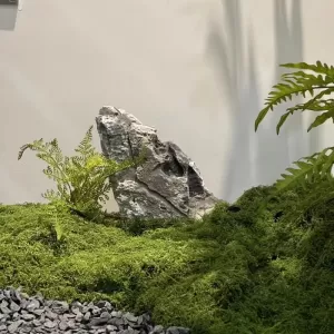 Artificial rock with moss and ferns for natural landscape decoration