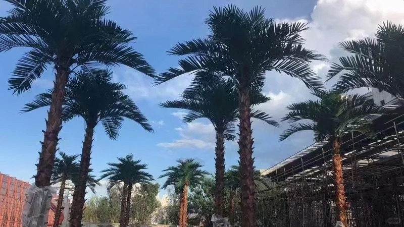 tropical landscape decor tall artificial palm trees against a blue sky