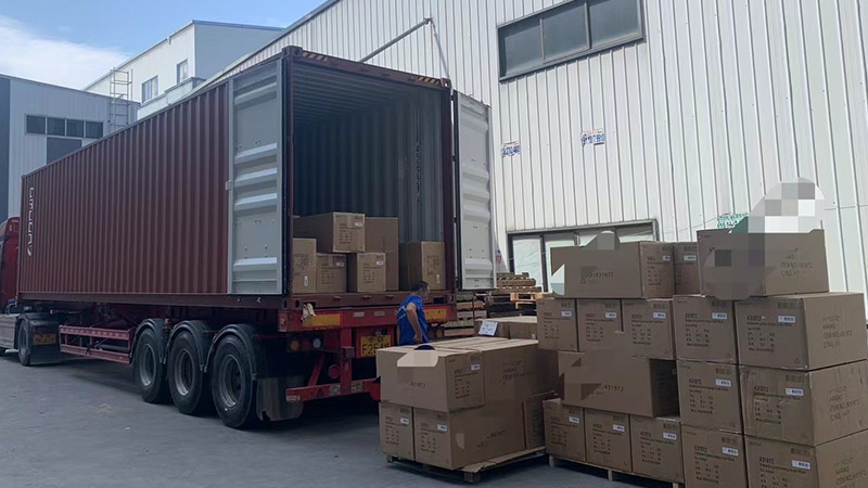 Shipping and Logistics Workers loading boxes into a shipping container