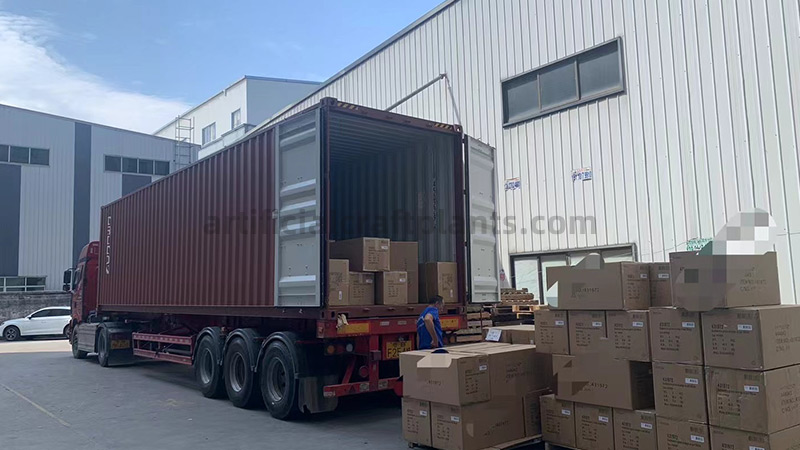 Unloading cardboard boxes from a shipping container truck