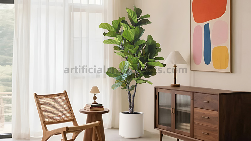 A tall, lush artificial Fiddle-Leaf Fig tree in a white pot, placed in a modern living room with minimalist decor.