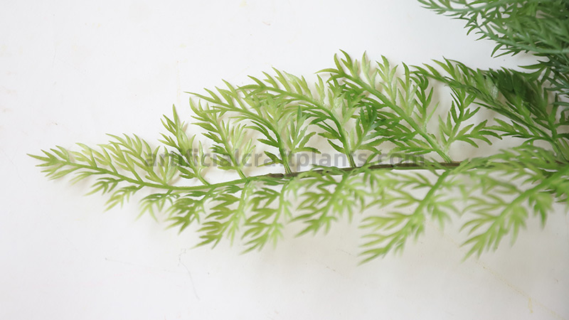 Artificial Fern Branch A close-up of a single artificial fern stem with delicate green leaves.