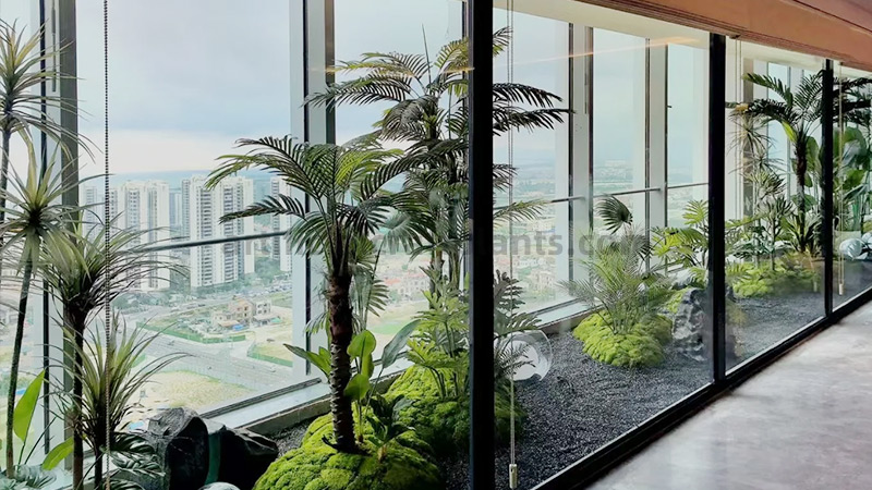 Artificial Balcony Garden Large indoor balcony garden with artificial palms, moss, and various green plants.