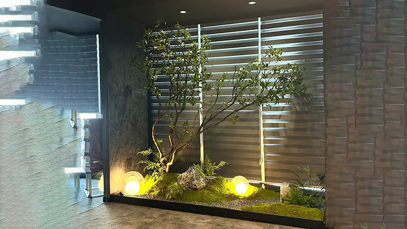 large artificial tree and plants in a modern indoor courtyard