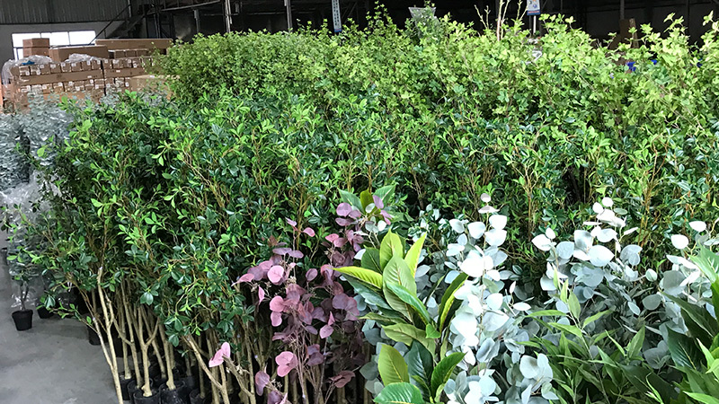 Artificial Plants Wholesale Warehouse filled with various types of artificial trees and plants for sale.