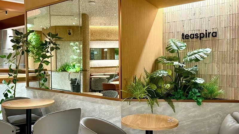 Artificial Tropical Plants large artificial tropical plants decorating a modern cafe interior