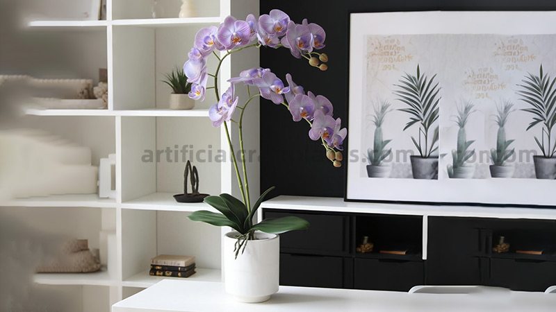 Artificial purple orchid Light purple phalaenopsis orchid in a modern white pot on a desk