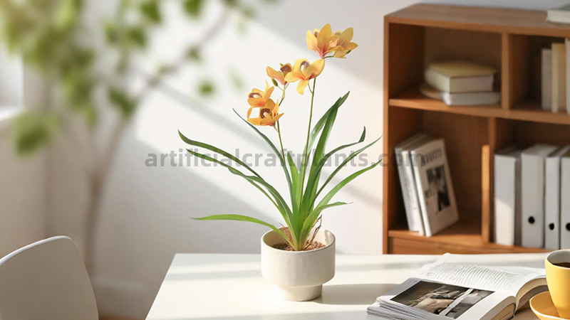 Artificial yellow orchid plant Yellow artificial orchid in a modern white pot on a desk