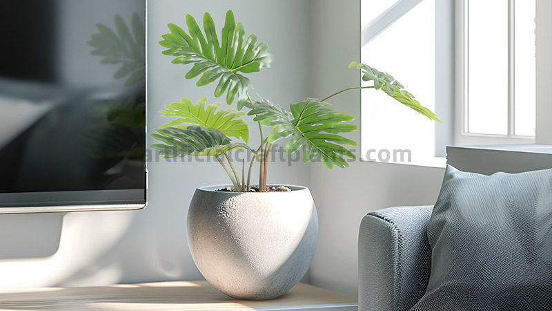 Faux Philodendron Plant Artificial split-leaf philodendron in cement planter by desk