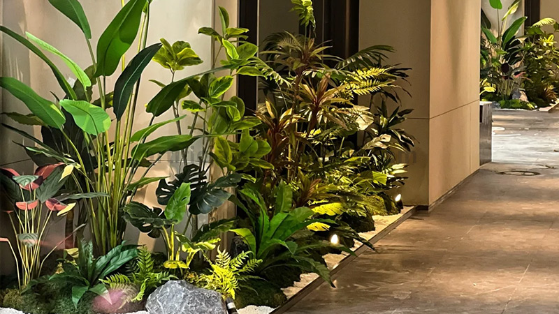Indoor Artificial Garden Indoor landscape with a variety of artificial plants, rocks, and moss.