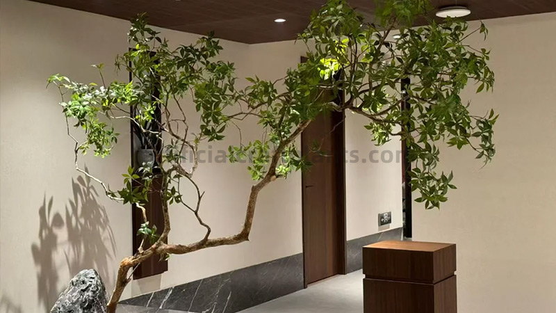 Large Artificial Tree Decor Large artificial tree with slender branches and green leaves in a modern interior.