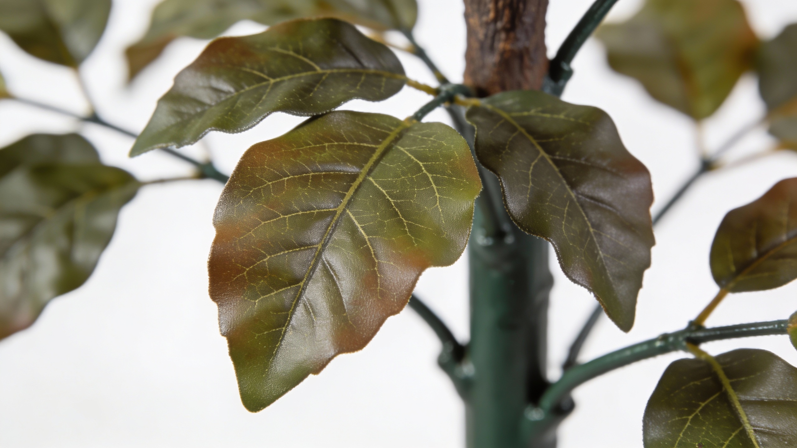 A detailed close-up of a UV-resistant polyethylene leaf and part of a steel trunk frame from a commercial faux palm tree.
